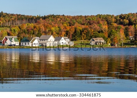Autumn landscape and cabins on lake shore in Elmore state park.