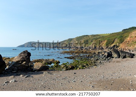 Coast and rocks at Kennack Sands Cornwall the Lizard Heritage coast South West England with blue sky on a sunny summer morning