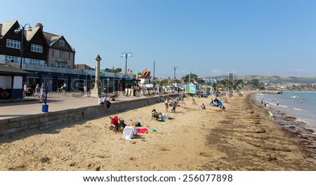 SWANAGE, DORSET, ENGLAND-SEPTEMBER 3  2014: Sunny weather brought families and visitors to Swanage beach  on the Dorset coast to enjoy the sand sea and summer sunshine on Wednesday 3rd September 2014