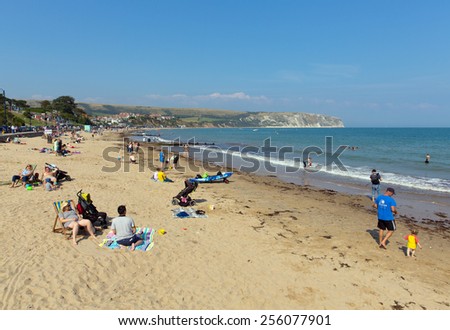 SWANAGE, DORSET, ENGLAND-SEPTEMBER 3  2014: Sunny weather brought families and visitors to Swanage on the Dorset coast to enjoy the beach waves and summer sunshine on Wednesday 3rd September 2014