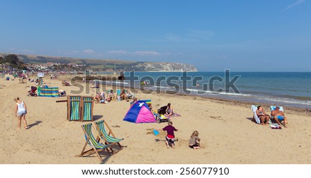 SWANAGE, DORSET, ENGLAND-SEPTEMBER 3  2014: Sunny weather brought families and visitors to Swanage on the Dorset coast to enjoy the beach waves and summer sunshine on Wednesday 3rd September 2014