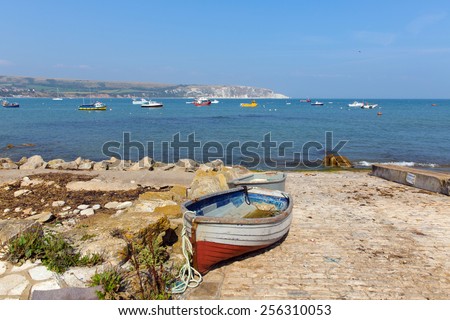 Rowing boat Swanage bay and coast Dorset England UK with blue sea and sky on a beautiful summer day on the English Jurassic coast