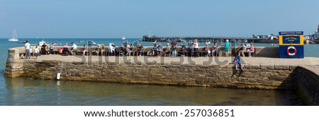 SWANAGE, DORSET, ENGLAND-SEPTEMBER 3  2014: Sunshine and warm weather brought visitors to Swanage on the Dorset coast to enjoy this popular seaside town on Wednesday 3rd September 2014