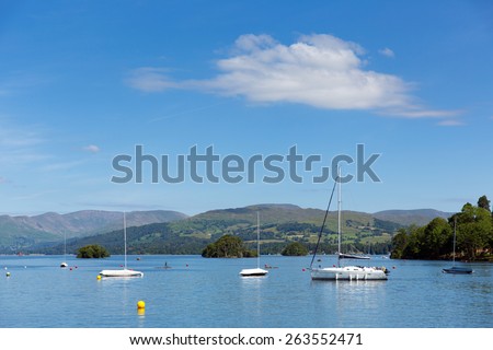 Lake District scene Bowness on Windermere The Lakes Cumbria UK on a beautiful summer day with blue sky mountains and sailing boats