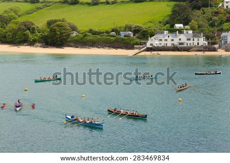 SALCOMBE, DEVON, ENGLAND-MAY  31ST  2015: Warm summer weather and good conditions assisted rowers competing in the popular  Pilot Gig Racing rowing event at Salcombe, Devon on Sunday 31st May 2015