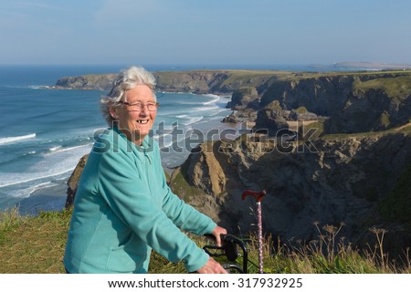 Active old lady pensioner by beautiful coastal view in summer
