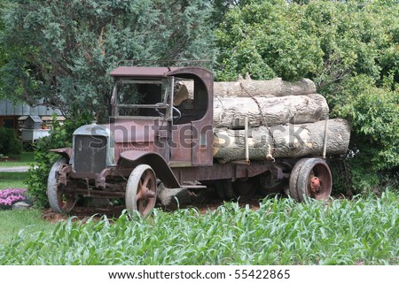 antique truck with load of logs