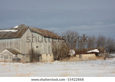 old grey Wisconsin dairy barn in winter