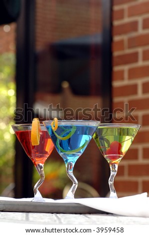 3 colorful alcoholic beverages ready to be served