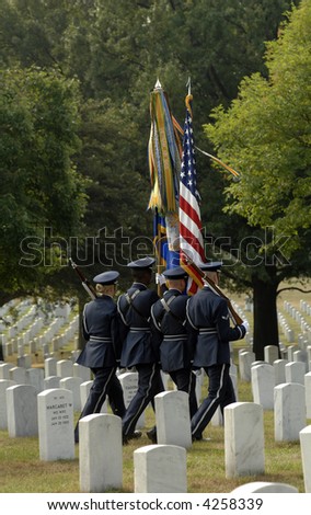 a color guard marches in Arlington Cemetery