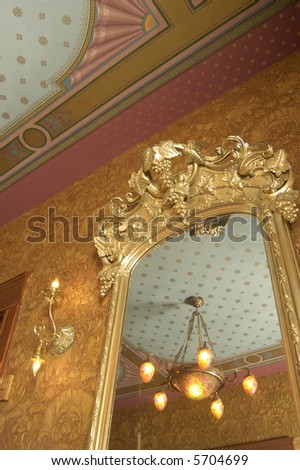 an ornate mirror and ceiling in a private home