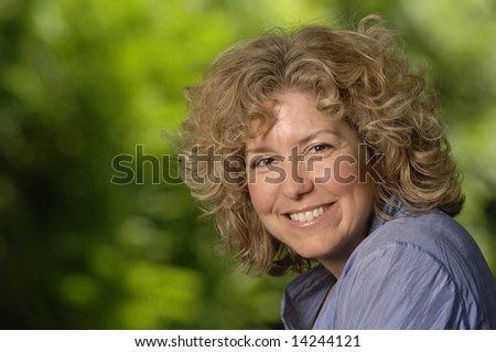 stock photo a pretty natural blonde woman with green background