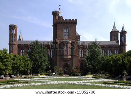 the castle and gardens of the Smithsonian Institution against a blue sky