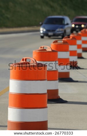orange highway barrels border road construction