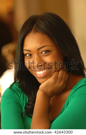 a beautiful young woman smiles looking into the camera