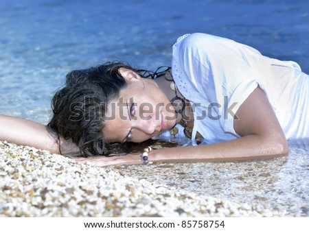 Pretty girl laying on the sandy beach/Sea Beauty