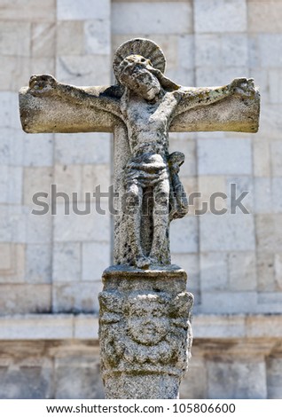 Cross with Jesus Christ in stone