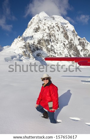 Tourist Walking in Deep Snow after Plane Landing on Pika Glacier in Denali National Park, Alaska near Mount McKinley