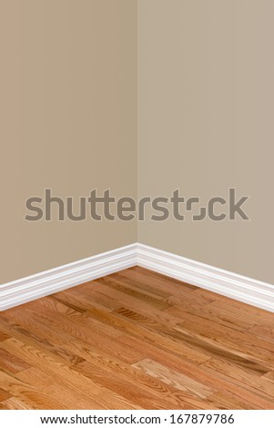 Corner of empty bedroom with view of hardwood floor, baseboard and walls