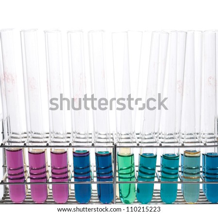 Test tubes with various colored liquids on test tube rack