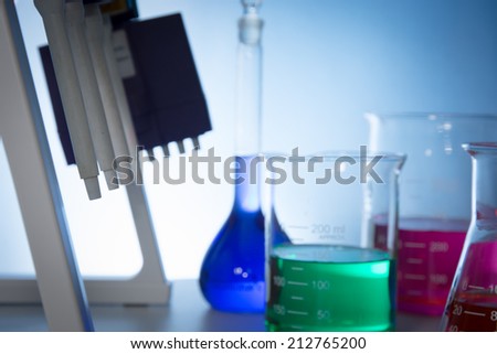 pipettor, liquid-moving and glassware with color water in desk