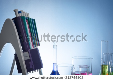 pipettor, liquid-moving and glassware with color water in desk