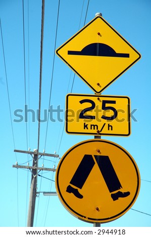 three yellow australian signs: retarder, speed limitation, pedestrian cross walk,