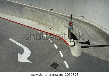 concrete and asphalt crossroad, no access sign, white arrow