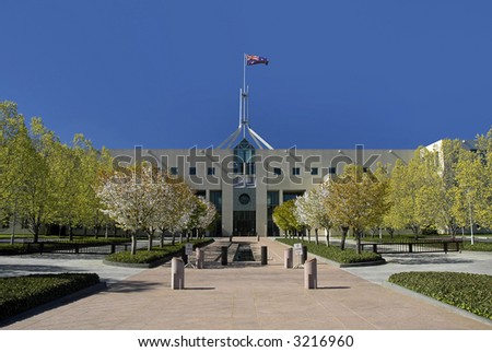 Parliament House in Australian capital city Canberra, waving flag