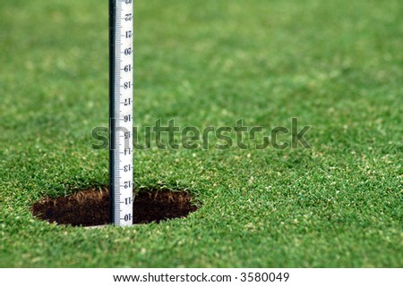green grass course, hole with white post