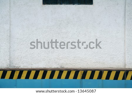 white wall background, black and yellow stripes,