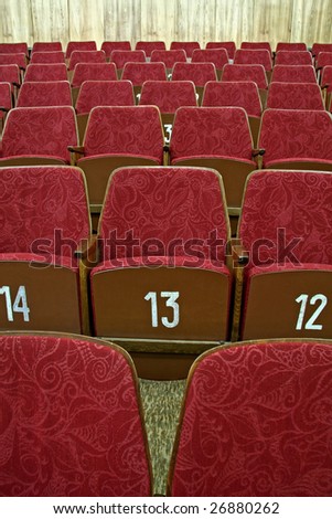 purple empty cinema seats with white numbers,