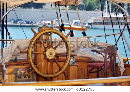 old wooden ship wheel on a yacht, detail photo