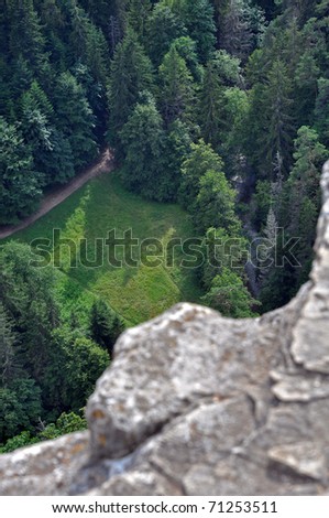 view from a rock, a meadow and some hills, climbing outlook, vertical composition