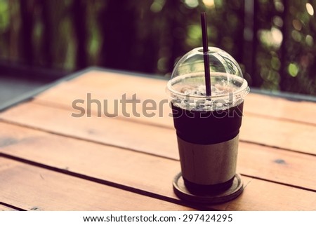 Black coffee without sugar into a glass of cold plastic.