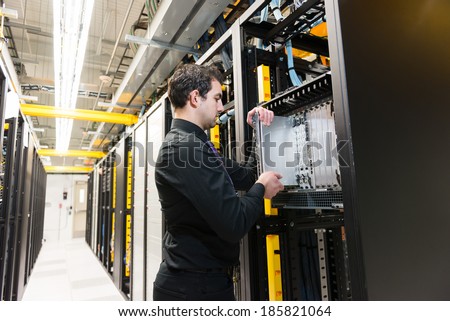 IT administrator installing a new rack mount server