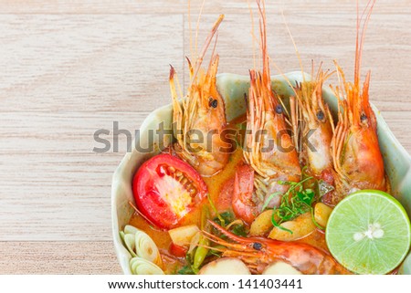 tom Yum Goong or spicy tom yum soup with shrimp. Thai popular food menu, contained in bowl.
