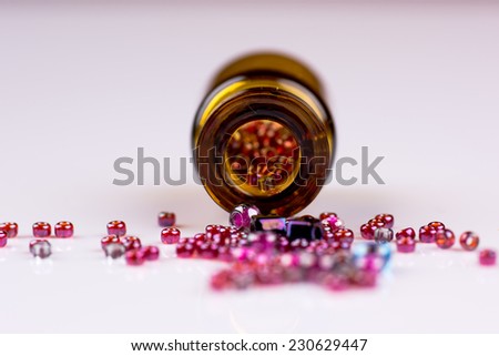 Spilled beads from orange bottle