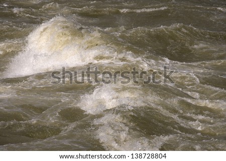 Brown River Rapids / Detail of rapids with brown water and spray
