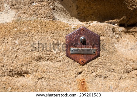 Old Doorbell on Wall - Tuscany Italy / Rusty doorbell button on brown stone wall in San Gimignano town (UNESCO heritage), Siena, Tuscany, Italy