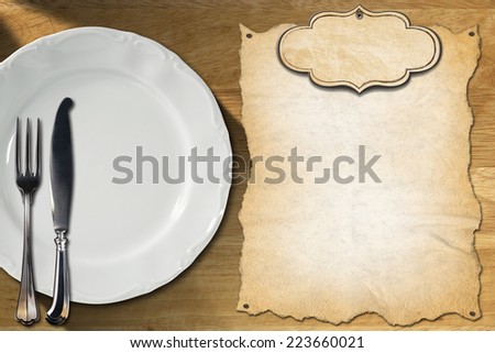 Restaurant Menu Design / Restaurant menu with empty white plate and silver cutlery, on wooden background with empty label and parchment