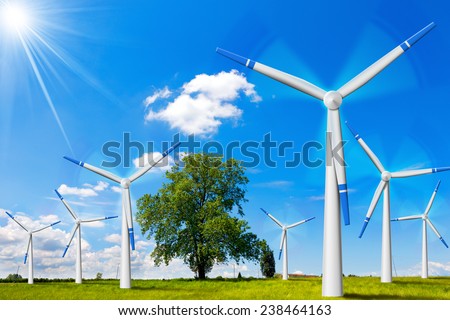 Electric Wind Generators in Countryside. Seven wind turbines in countryside with tree, blue sky, clouds and sun rays