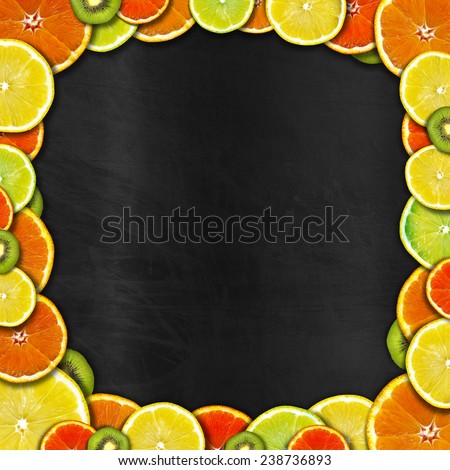 Blackboard with Fruit Frame. Frame of oranges, lemons and kiwi on an empty blackboard