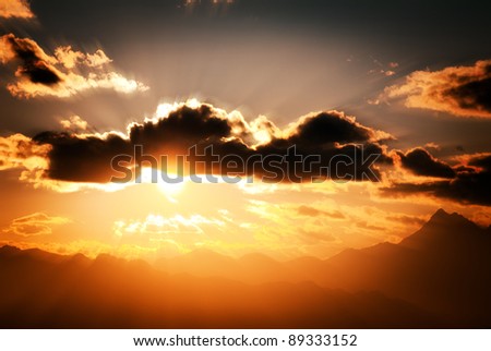 sky clouds and sun in mountain landscape