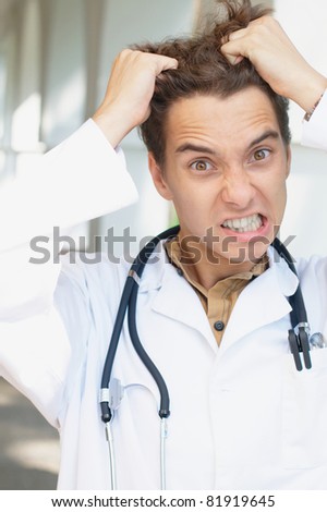 Close-up funny photo of an angry doctor