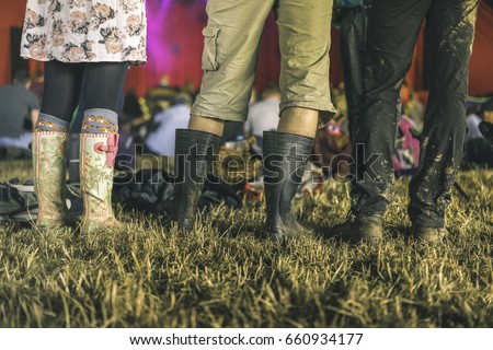 3 pairs, Festival wear in an indoor tent, Glastonbury, England, United Kingdom