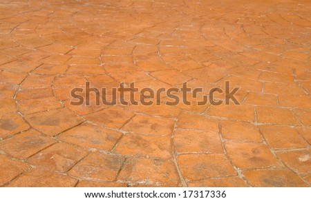 Red Stamped Concrete Patio in Backyard