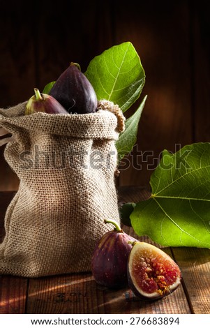 close up view of fresh figs and  leaf on color back