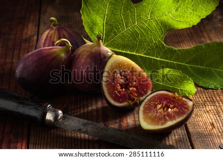 close up view of fresh figs and knife on color back