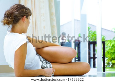 high-key portrait of young woman laying on the floor awaiting her boyfriend